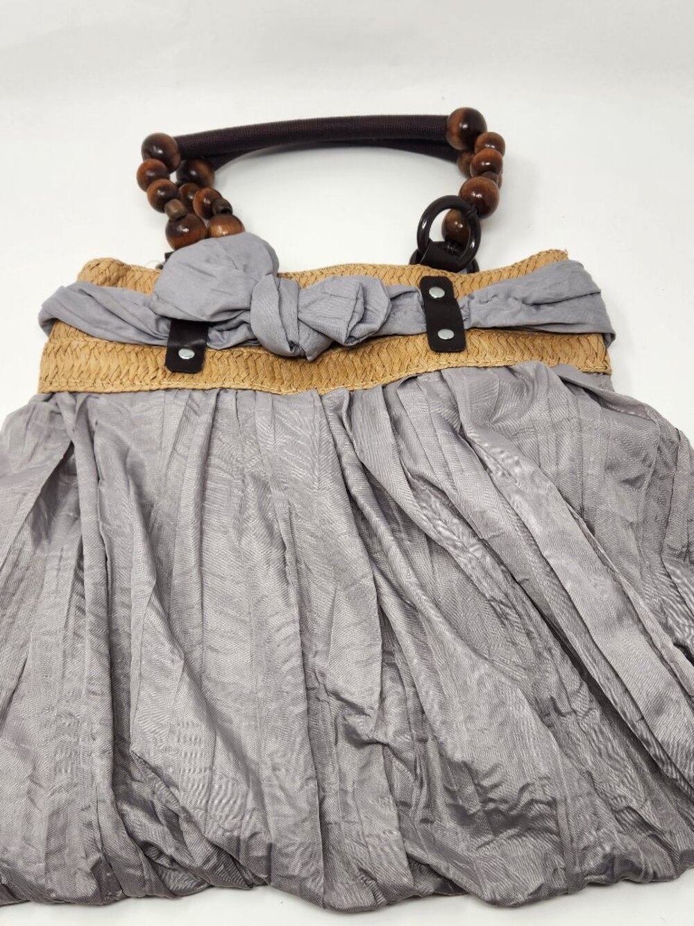 New gray cloth handbag with tan straw band and dark brown bead handle.